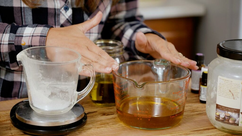 Ingredients on a wooden counter for homemade healing salve.