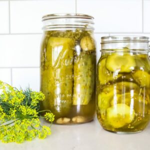 placing dill in mason jar crunchy dill pickles on table