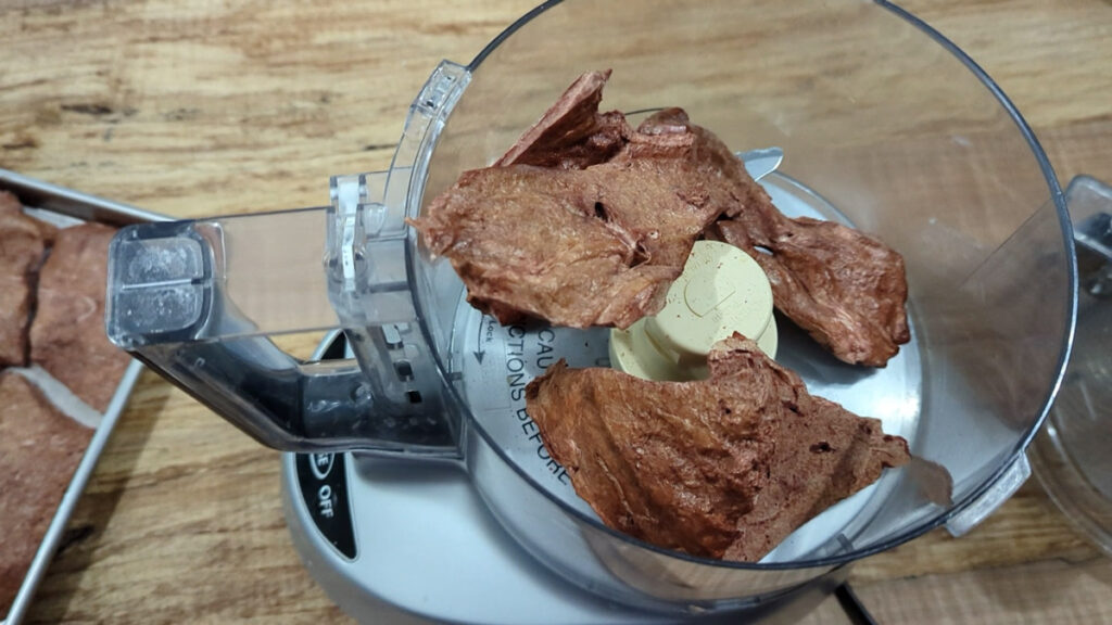Freeze-dried beef liver pieces in a food processor.