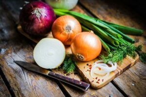 Vegetables on a cutting board with a knife.