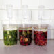 Three jars of peppers in fermenting jars.