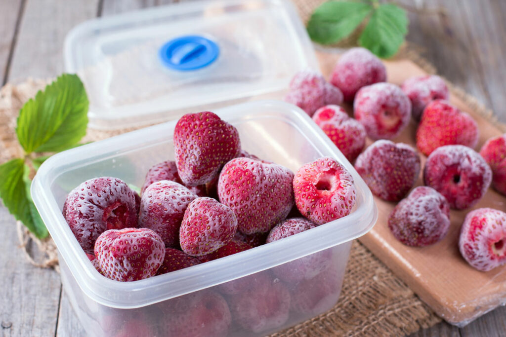 Frozen strawberries in a container.