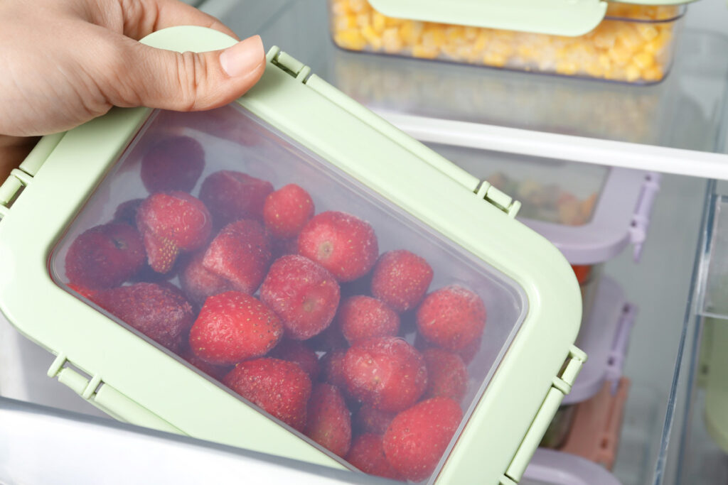 Fresh strawberries in an airtight container in the refrigerator.
