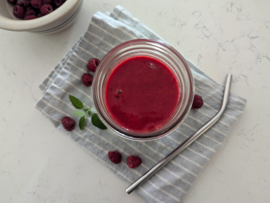 Fresh raspberry juice in a glass.