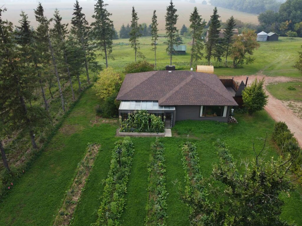 Overhead view of a food forest garden and a homestead.