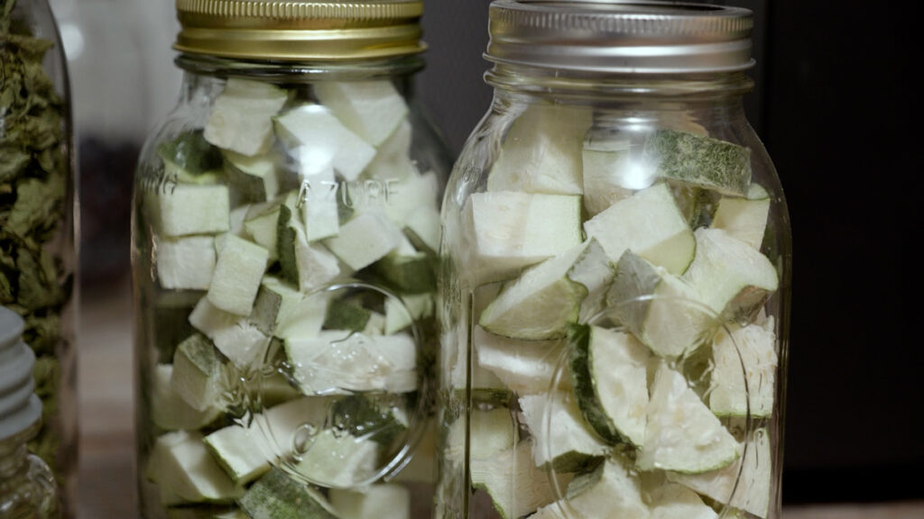 Two jars of cubed freeze dried zucchini.