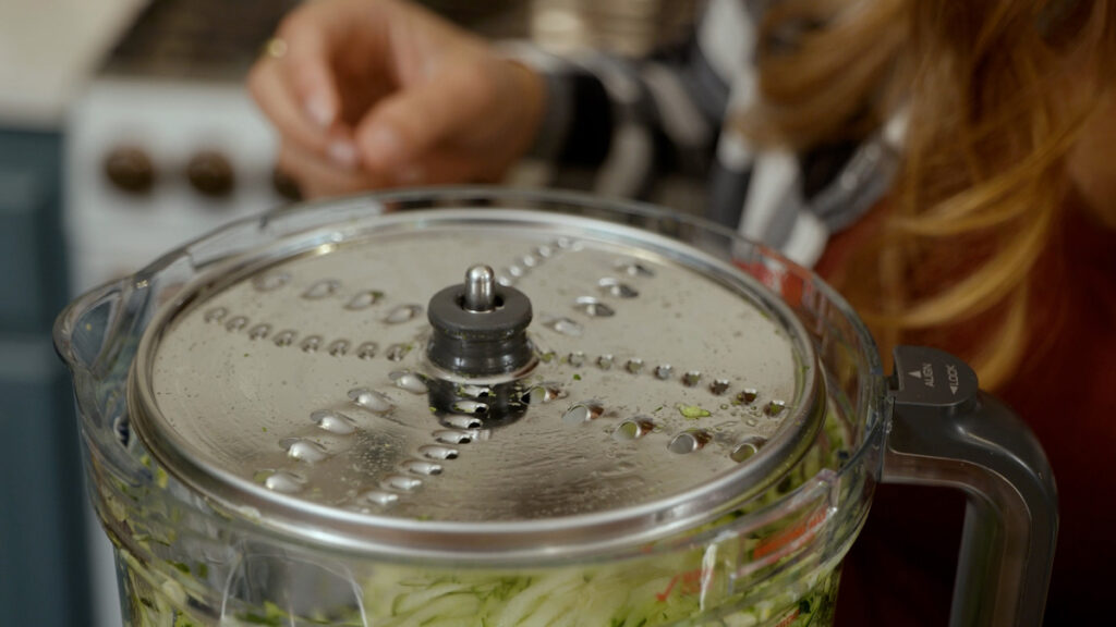 Shredded zucchini in a food processor.