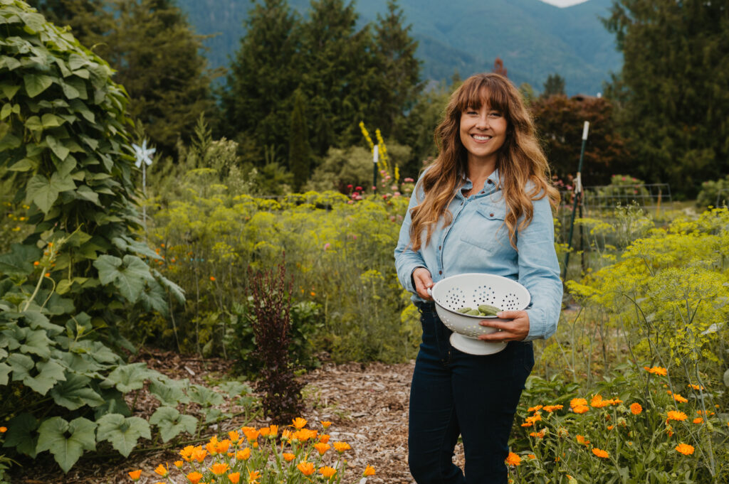 A woman harvesting produce from the garden.