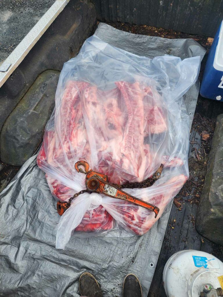 Beef bones packaged up in plastic in the bed of a truck.