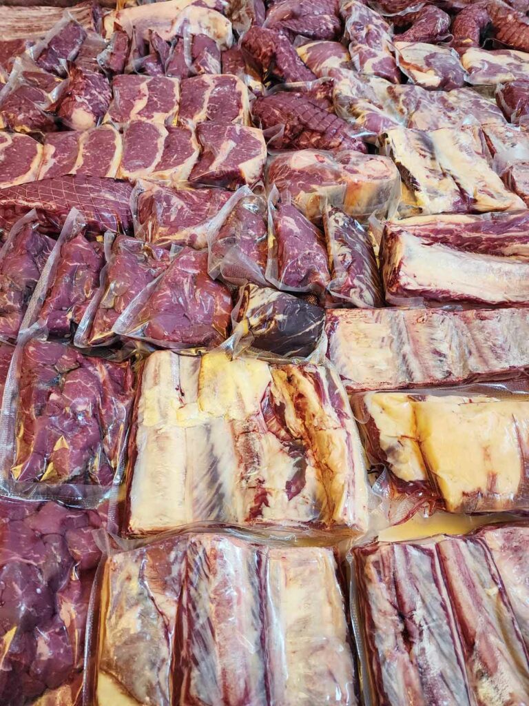 Various cuts of beef all laid out on a table.