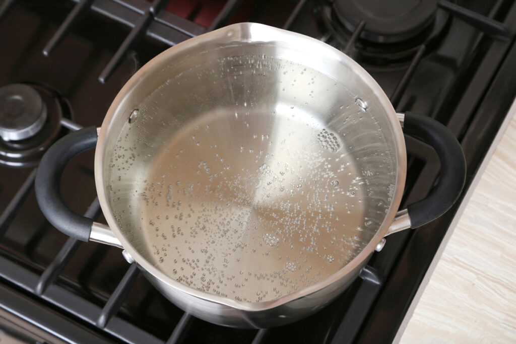 Boiling water in a pot on the stove.