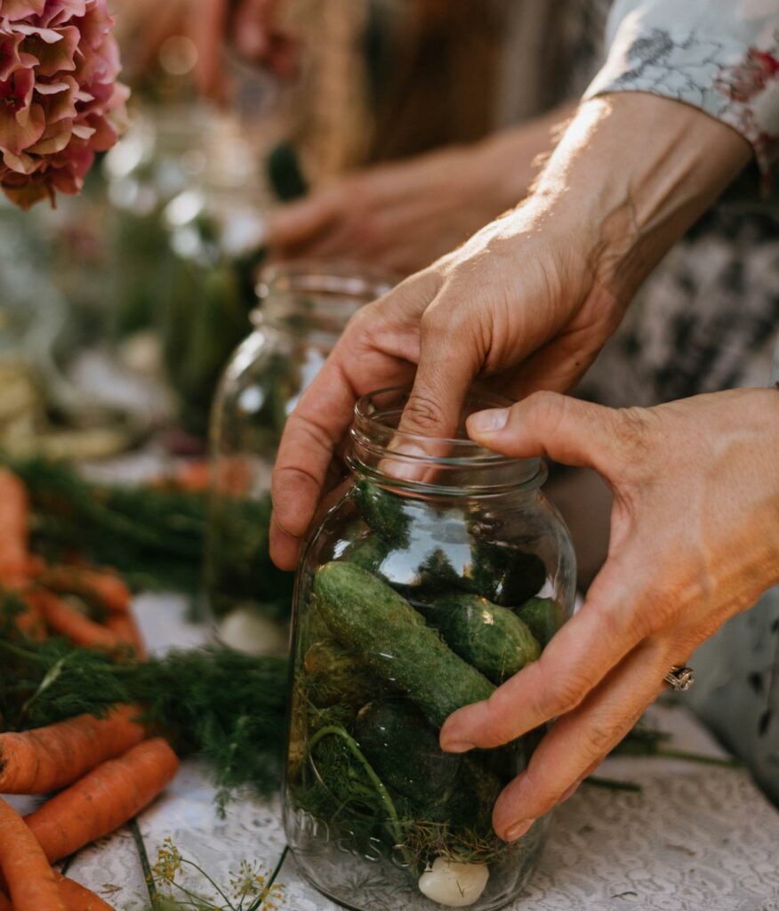 People making fermented pickles at a long table.