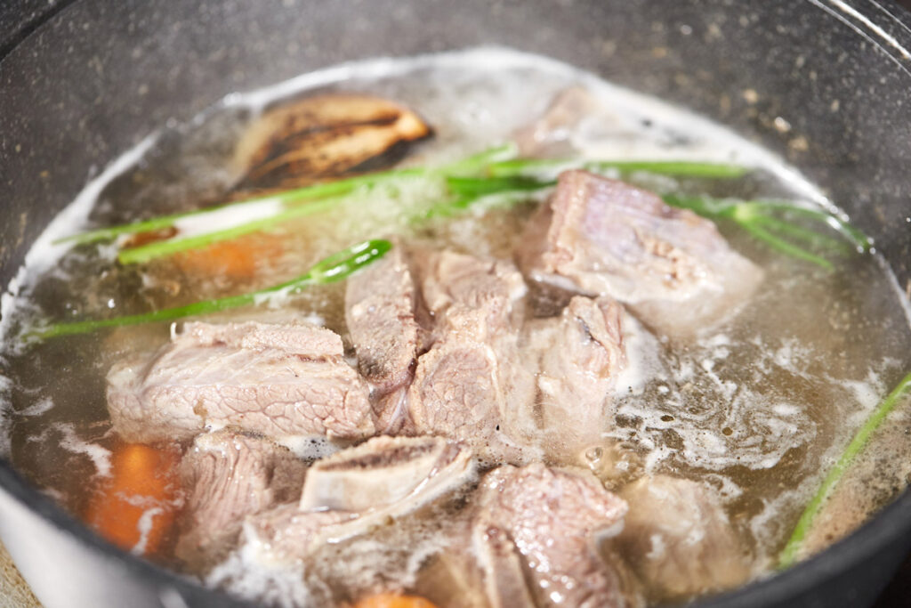 Meat stock in a large pot.