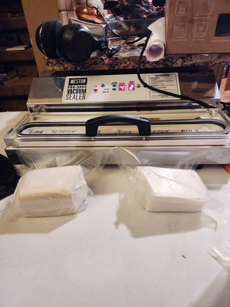 Packages of lard being vacuum sealed.