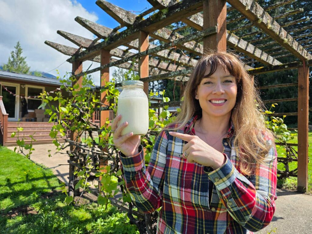 A woman holding a jar of lard.