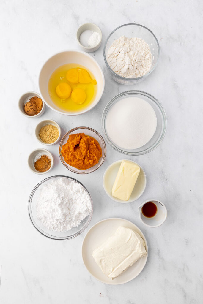 Ingredients needed for a homemade pumpkin roll cake.