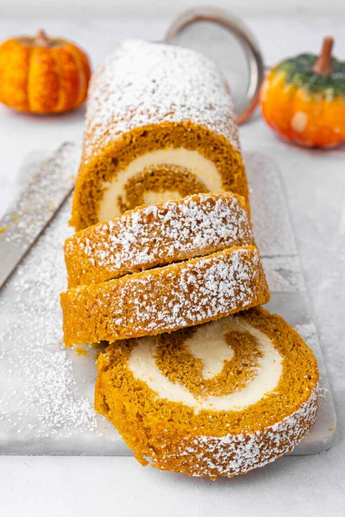 Slices of pumpkin roll on a counter.