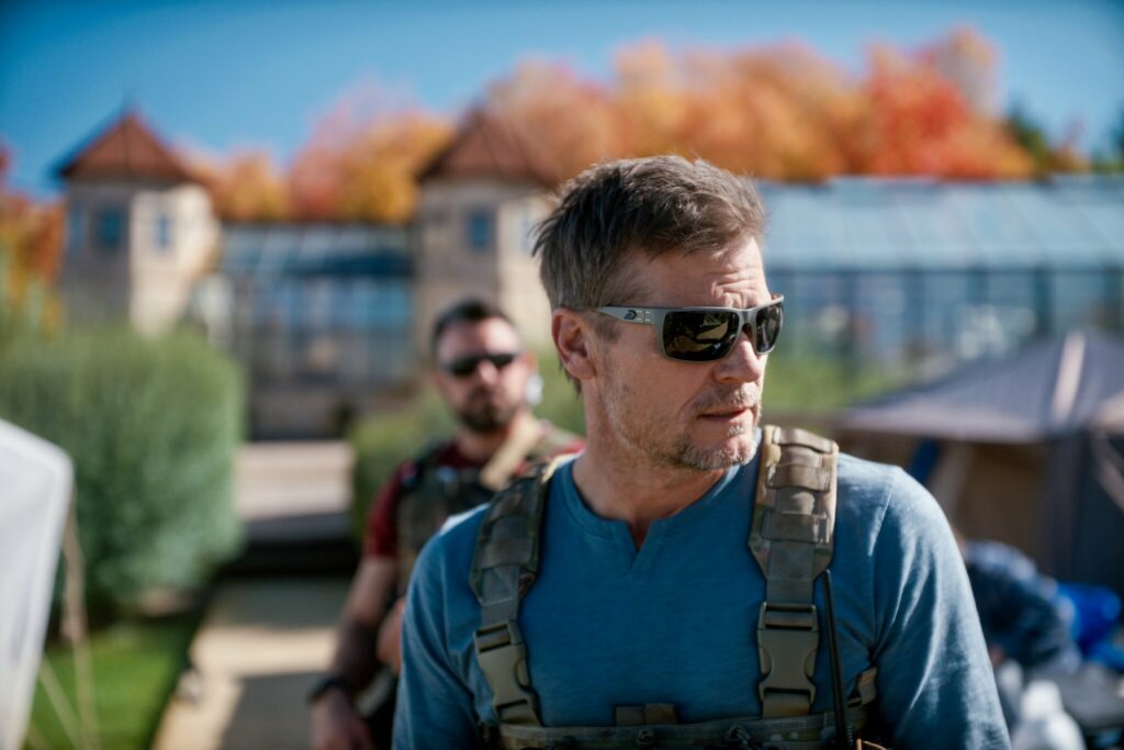 Screenshot of two military men guarding a mansion from the film Homestead.