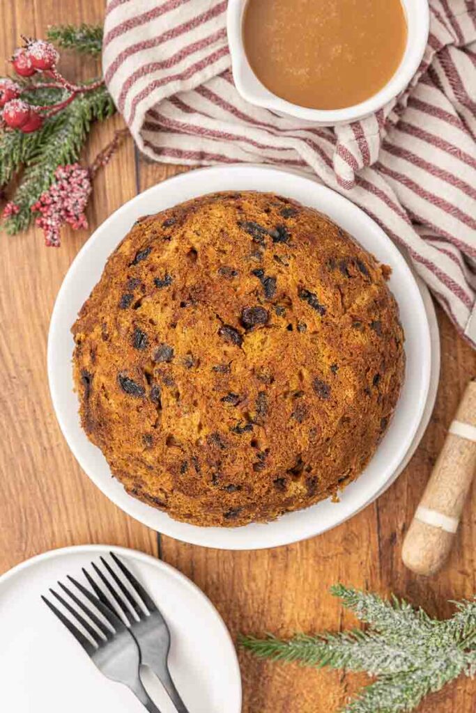 Christmas pudding on a white serving platter.