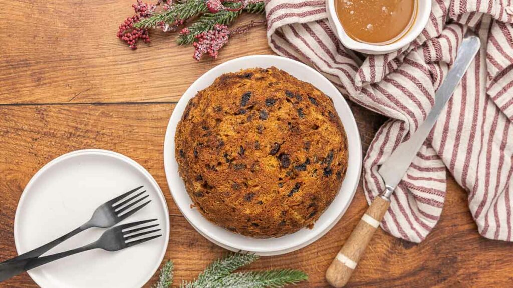 Christmas pudding on a white serving platter.