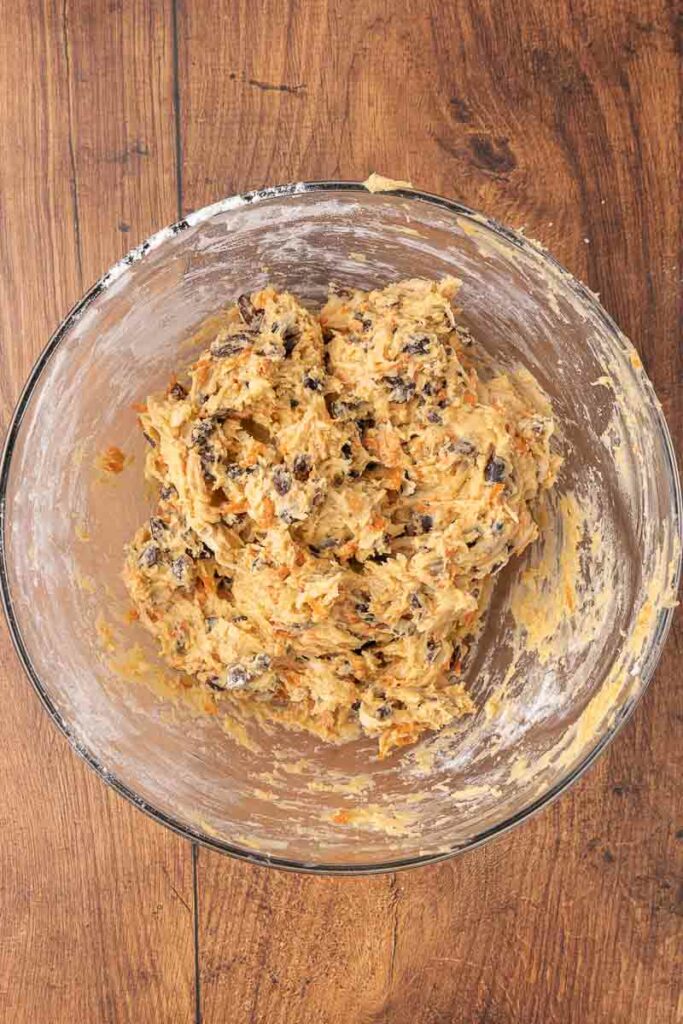 Christmas pudding batter in a glass bowl.