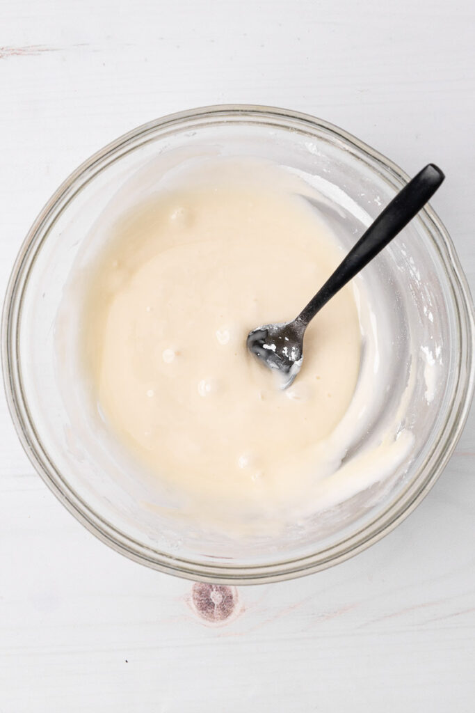 Maple glaze icing in a glass bowl.