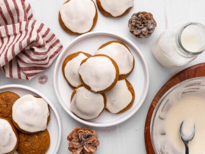 Ginger cream cookies on a plate with holiday decor on the table.