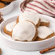 Ginger cream cookies on a plate with holiday decor on the table.