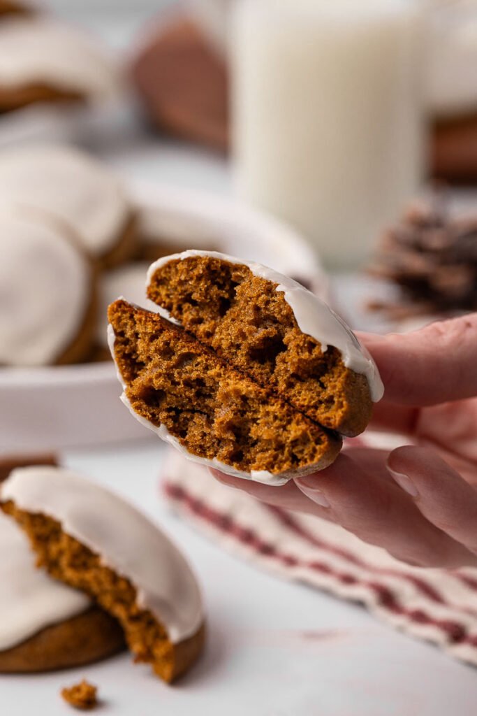 Ginger cream cookie broken in half.