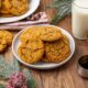 A plate full of molasses cookies with another in the background.