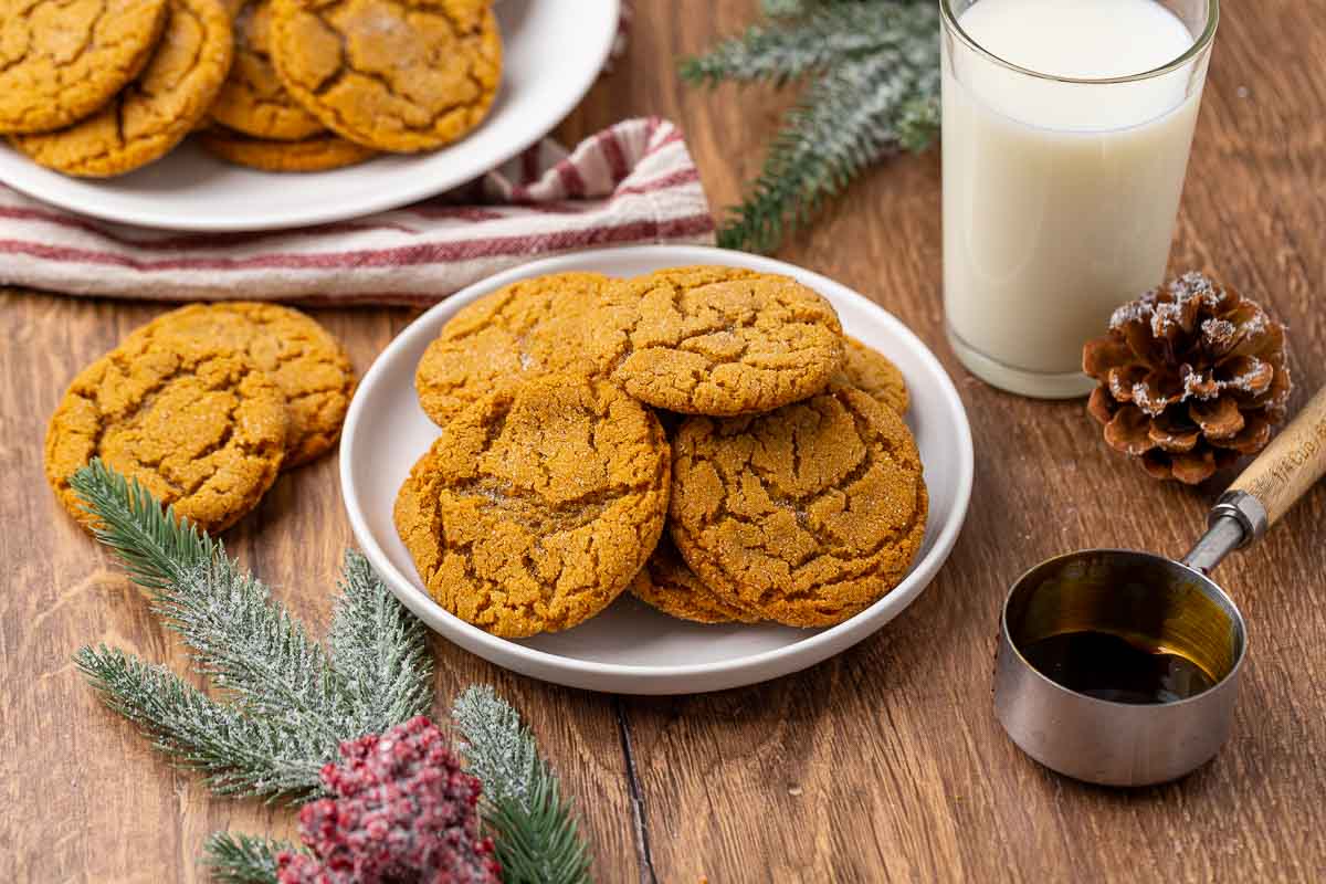 A plate full of molasses cookies with another in the background.