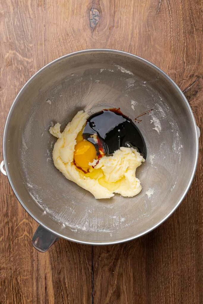 The wet ingredients for molasses cookies in a mixing bowl.