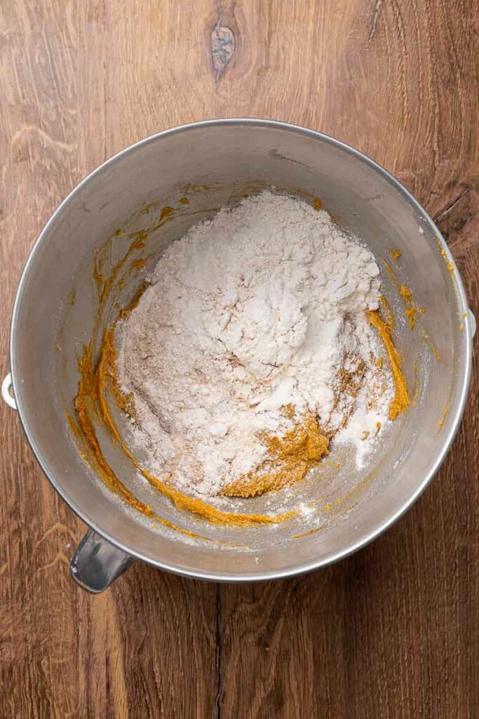 The mixture for molasses cookies in a mixing bowl.