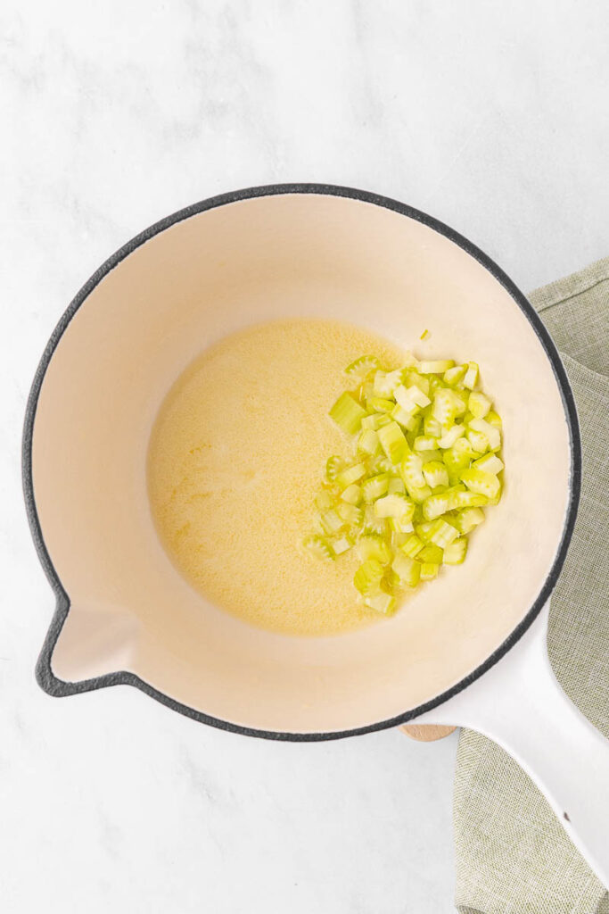 Celery being added to the melted butter.