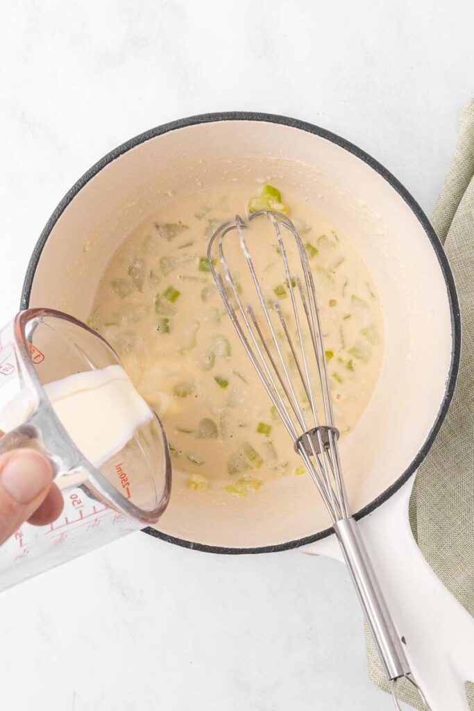 Cream being added to the celery soup.