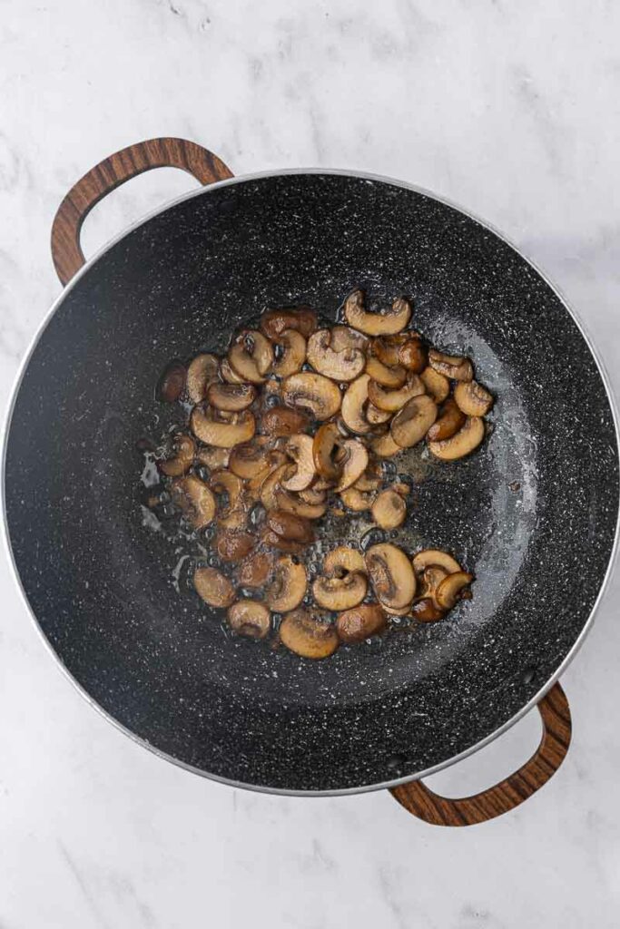 Sauteed mushrooms in a pan.