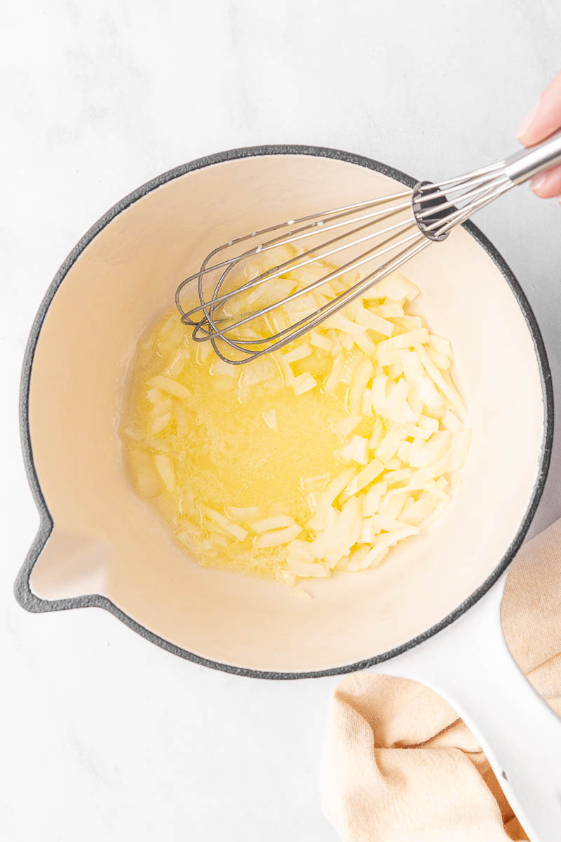 Onions saut&eacute;ing in melted butter.