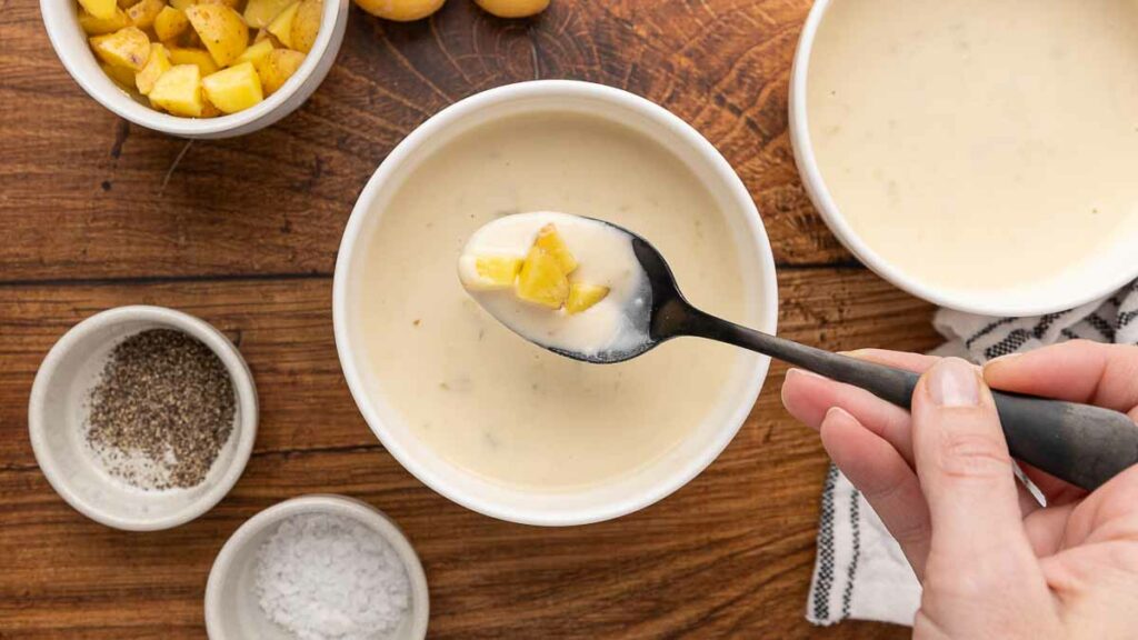 Cream of potato soup with a spoonful.