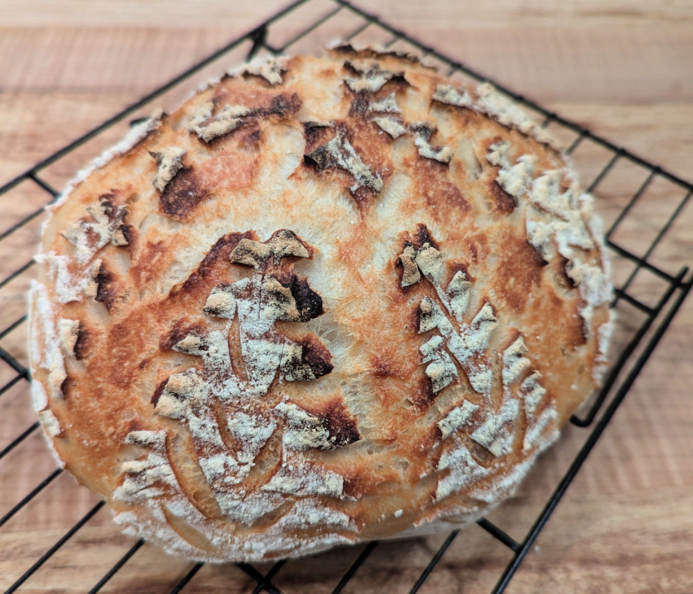 Sourdough boule on a wire cooling rack.