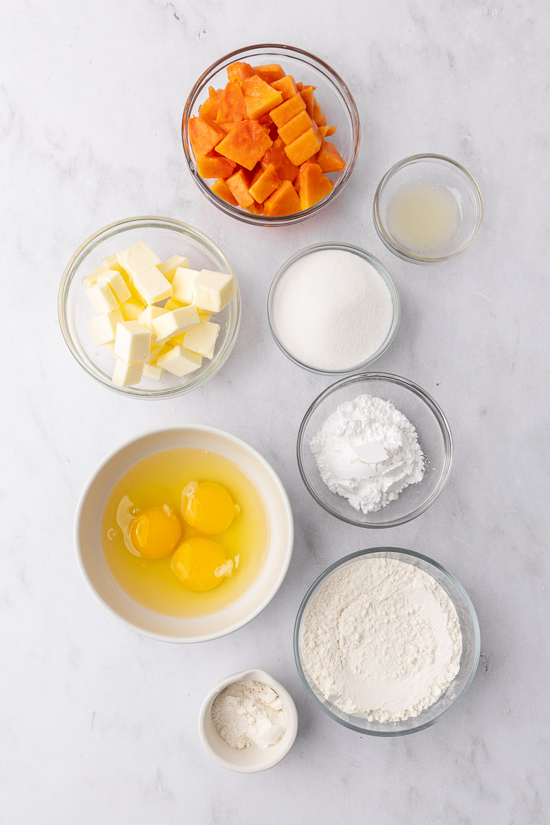 Ingredients to make papaya bars in small glass bowls.