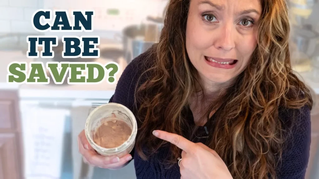 A woman holding an old jar of sourdough starter.