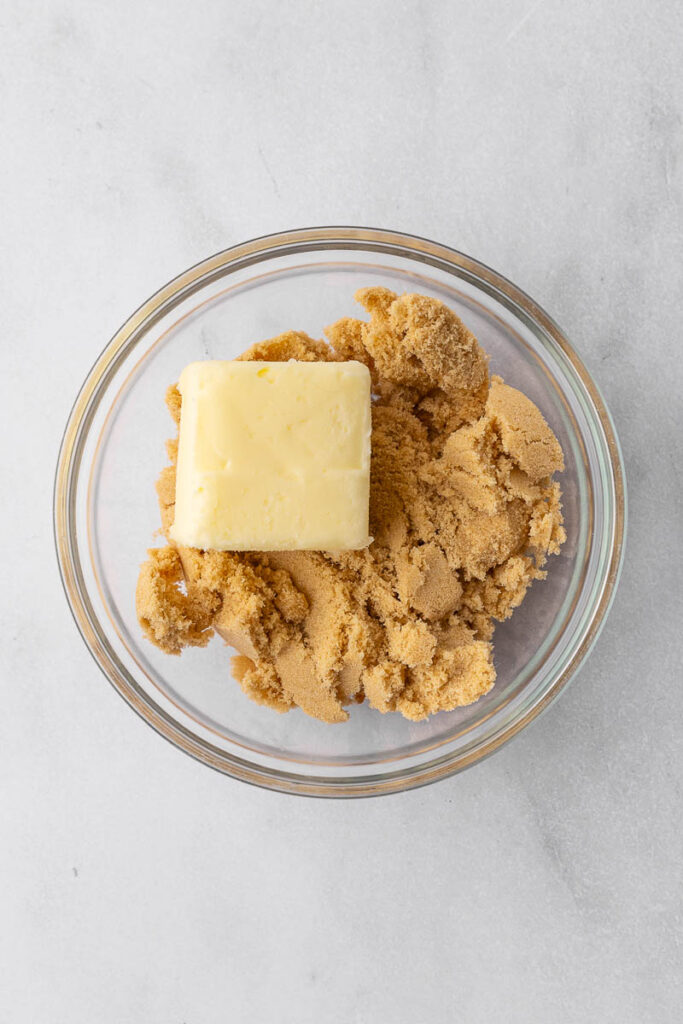 Brown sugar and butter in a glass bowl.