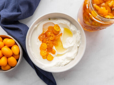 Candied kumquats in a bowl of yogurt.