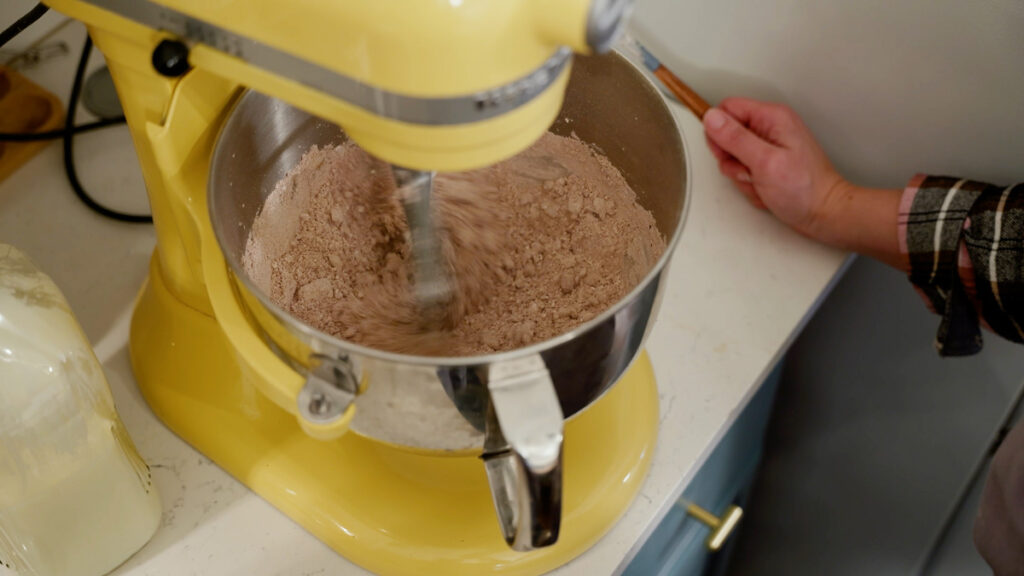 Ingredients for chocolate buttercream frosting in a stand mixer.