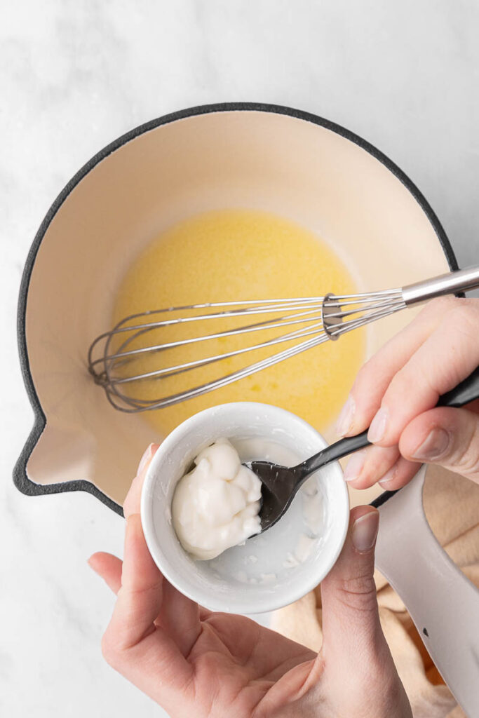 Gluten free thickening agents being added into melted butter.