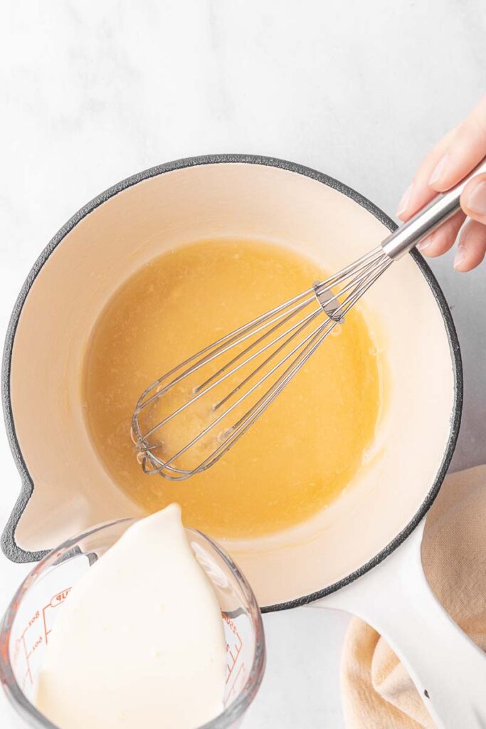 Cream being added into a gluten free cream of chicken soup.