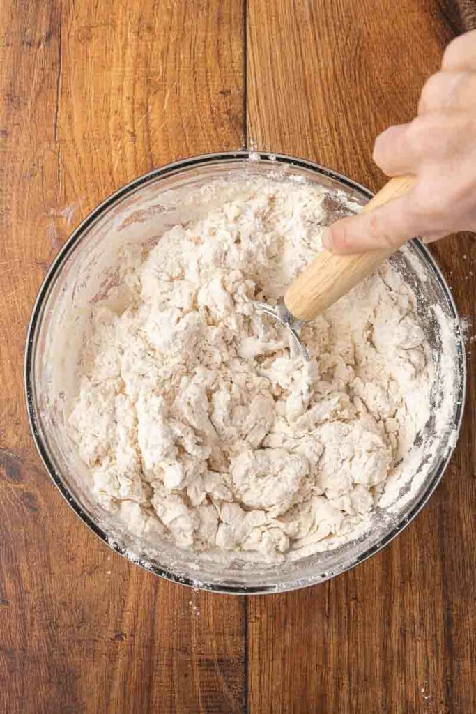 Whisking together the dough for no-knead bread.