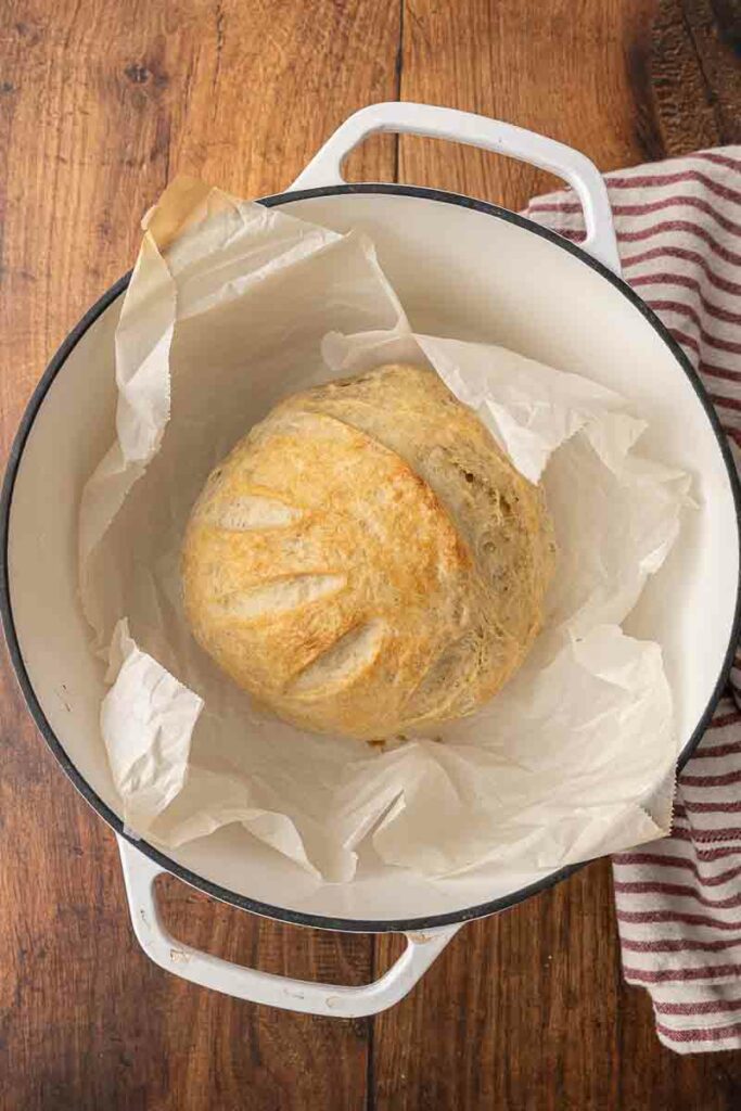 Finished loaf of artisan bread in a Dutch oven.