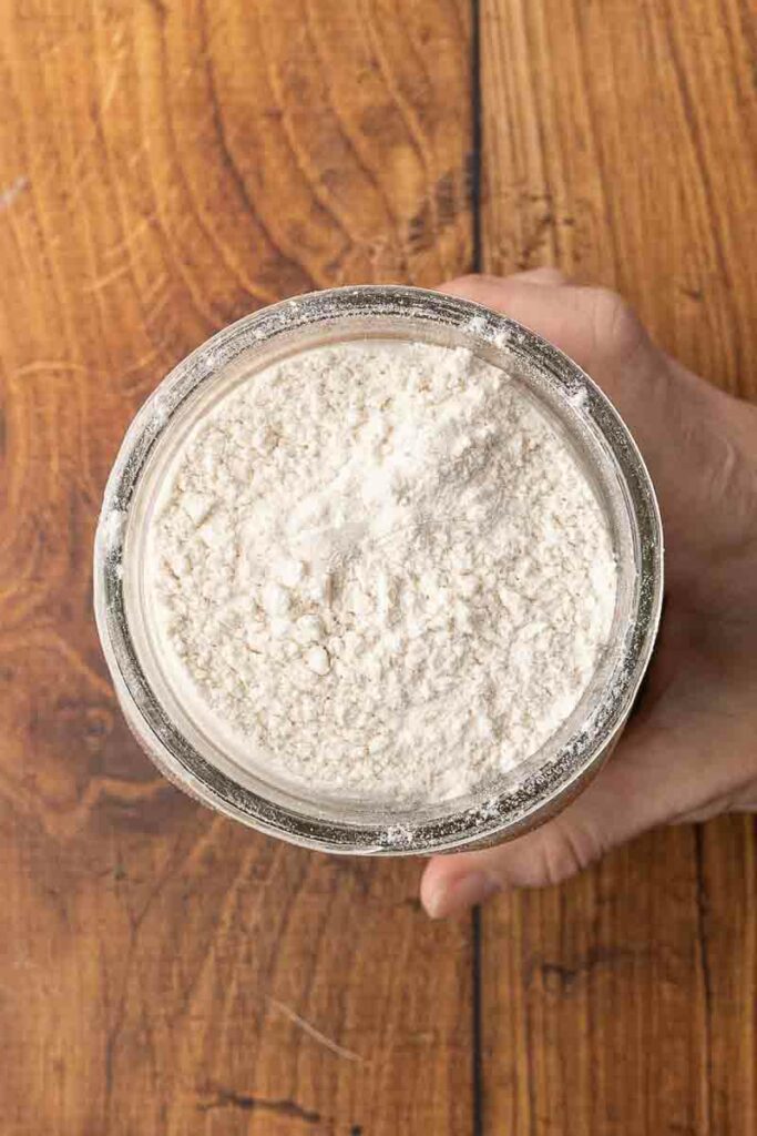 Overhead photo of no-knead bread dough in a Mason jar.