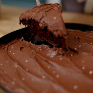 A slice of chocolate wacky cake on a serving utensil.